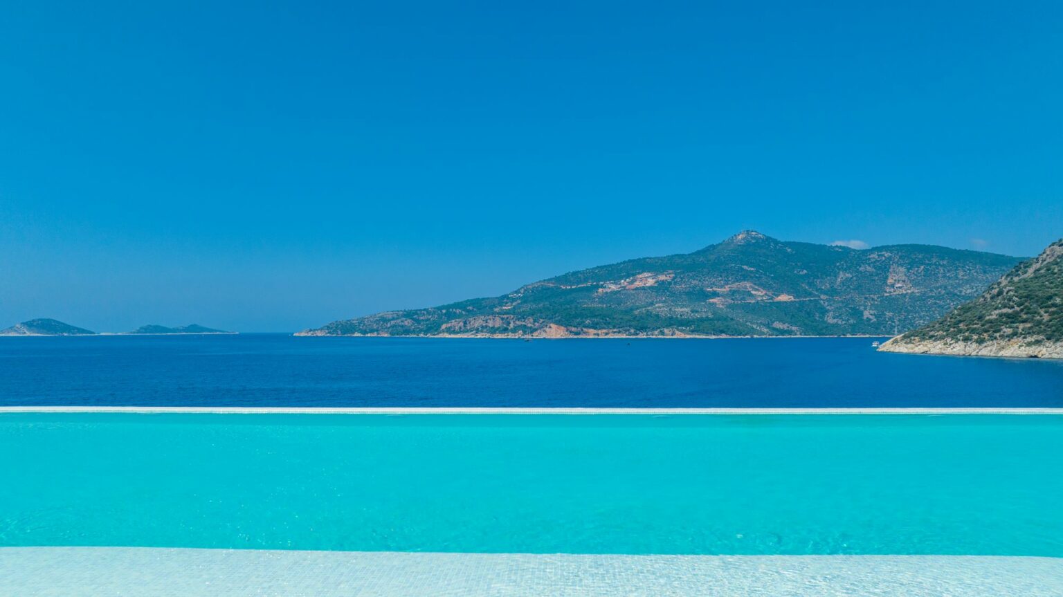 Infinity pool overlooking the Mediterranean at The Lures Hotel, Kalkan — luxury boutique hotel on Turkey’s Turquoise Coast offering early booking savings for 2026.