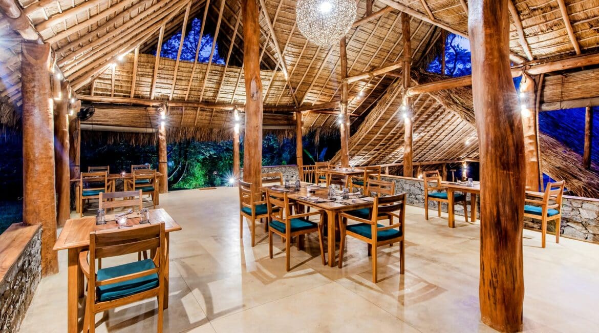 Gal Oya Lodge dining room – Open-sided indoor-outdoor dining space blending natural materials and jungle views in Gal Oya National Park, Sri Lanka.