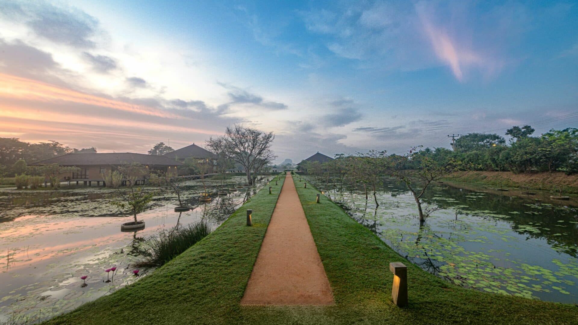 Serene morning light over Water Garden Sigiriya’s tranquil walkways, surrounded by water gardens and lush greenery in Sri Lanka’s Cultural Triangle