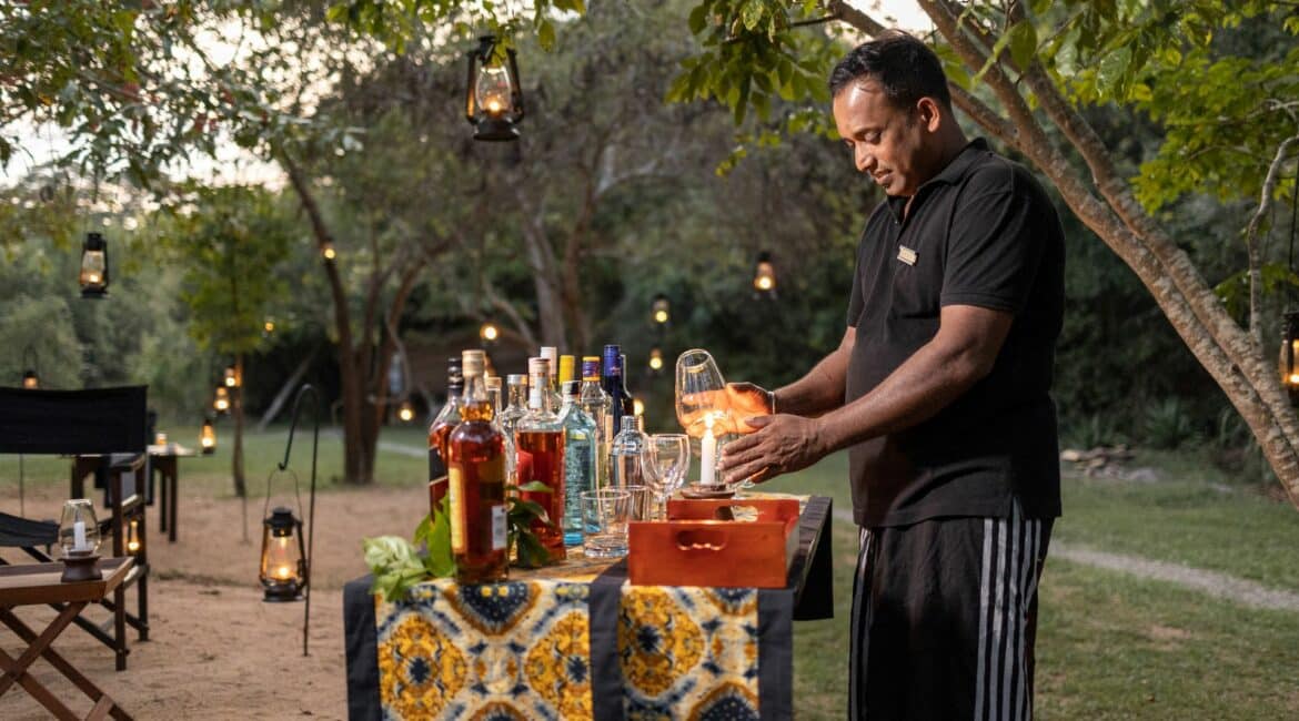 Leopard Trails Wilpattu Camp Bar – Sundowners being expertly poured by the team, capturing the relaxed, elegant atmosphere of safari evenings in Sri Lanka.