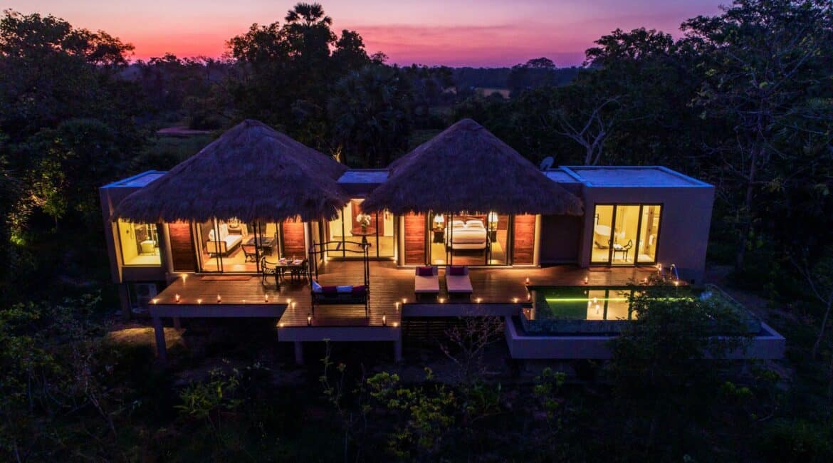 Deluxe Pool Villa at Uga Ulagalla at dusk, softly lit against the evening sky – luxury hideaway in Sri Lanka’s Cultural Triangle.