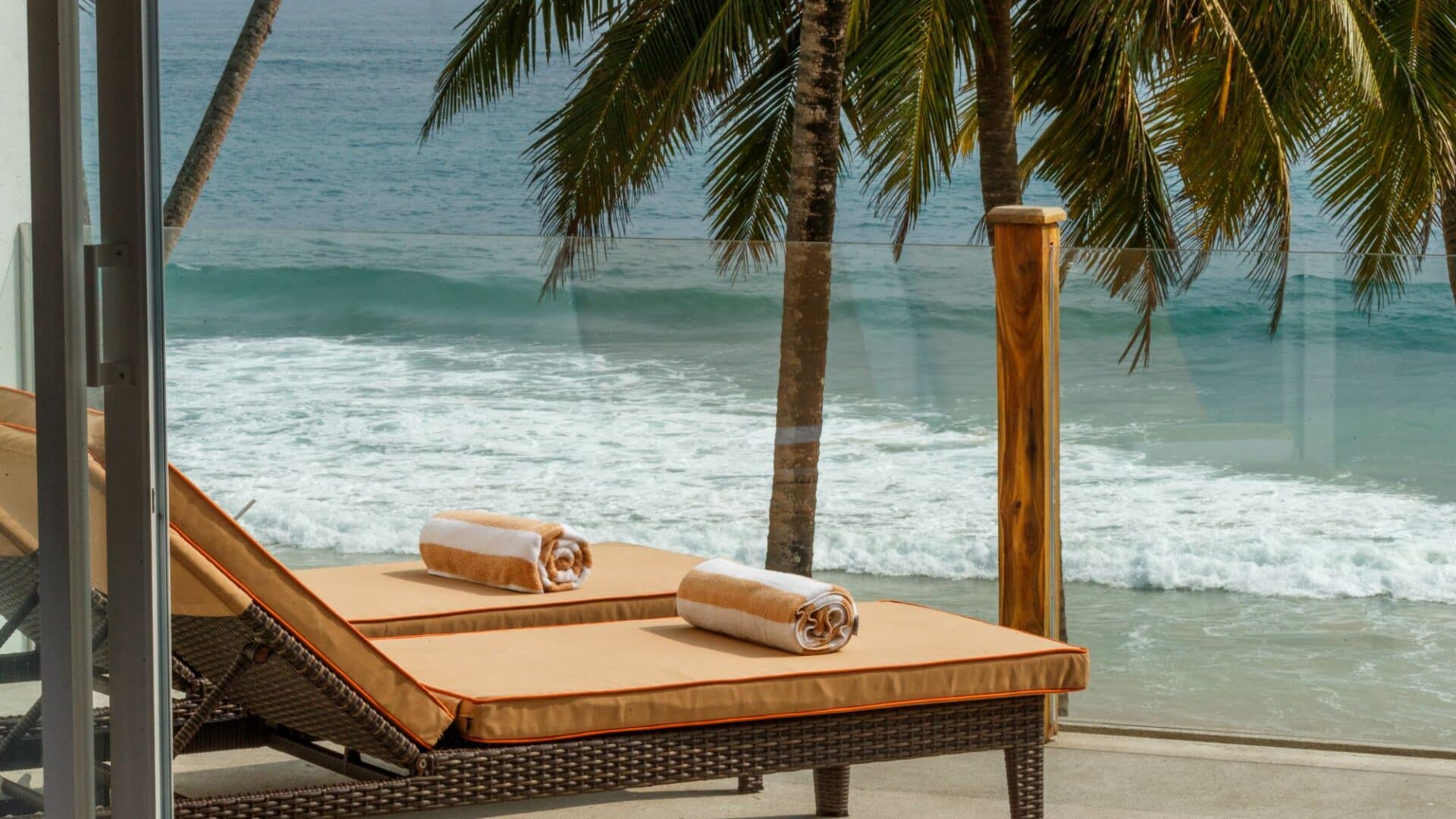 KK Beach Ocean Penthouse Suite – beautifully furnished terrace with daybeds and panoramic sea views.