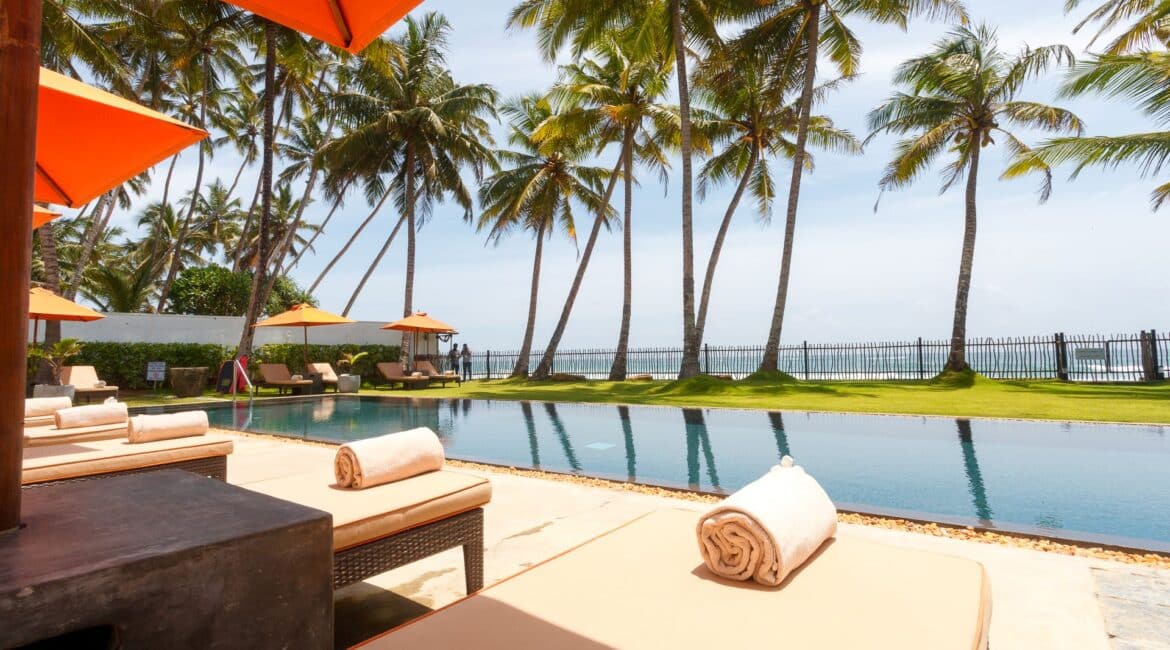 KK Beach swimming pool and palm tree skies