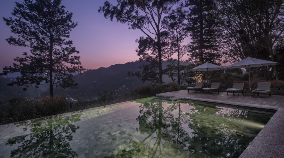 Hill Country landscape seen from poolside at Nine Skies, a tea estate retreat in Sri Lanka