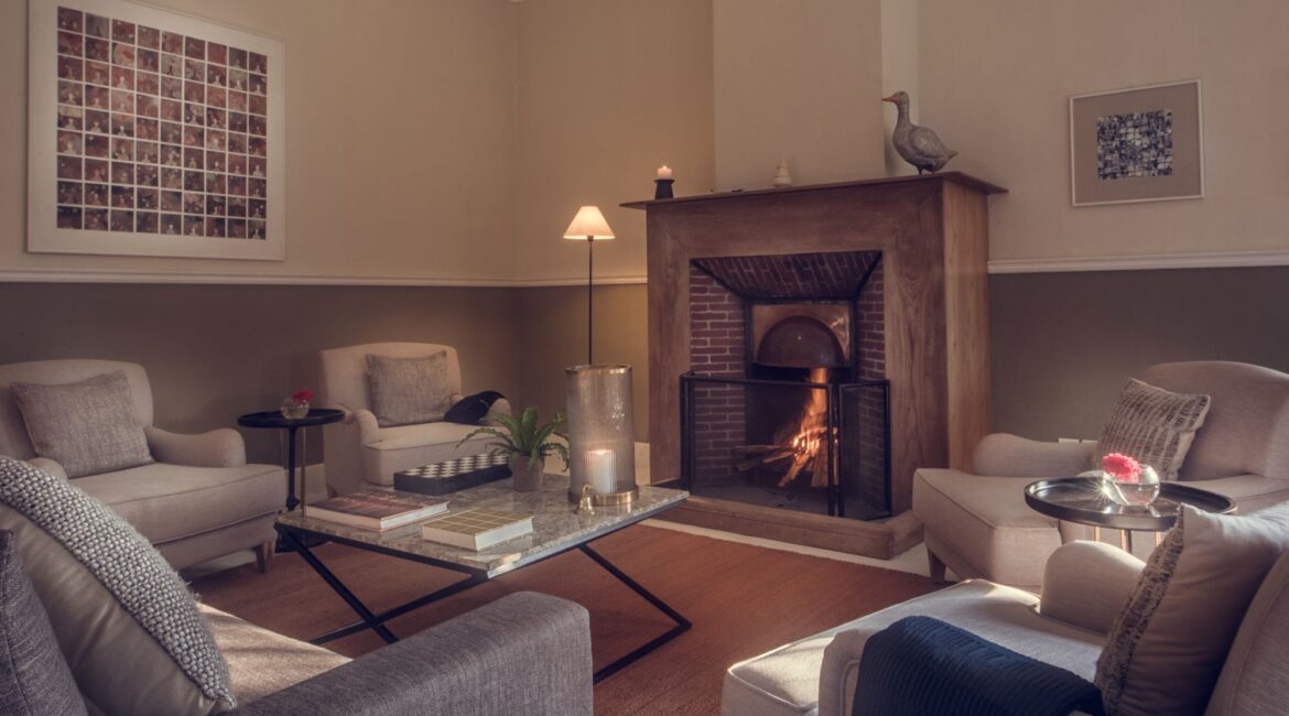 Cosy sitting room with roaring fire at Nine Skies tea bungalow in Sri Lanka’s Hill Country