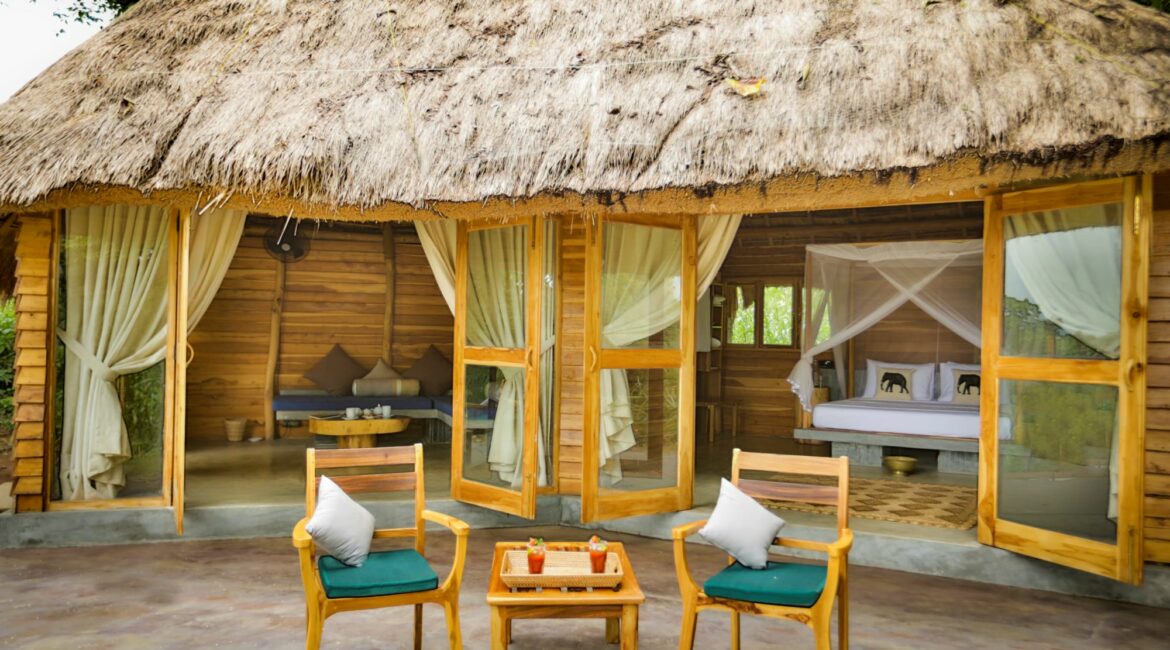 Gal Oya Lodge bungalow suite with alfresco sitting area and stylish indoor lounge, blending natural design with views of Gal Oya National Park, Sri Lanka