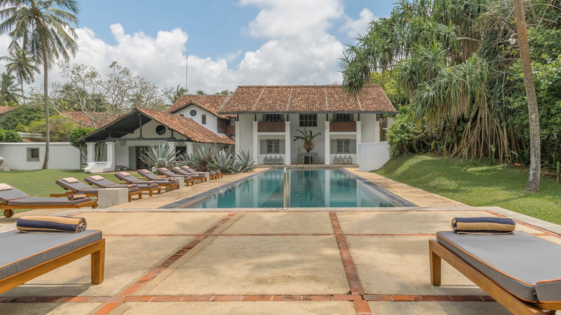The Villa Bentota swimming pool against the hotel backdrop by day