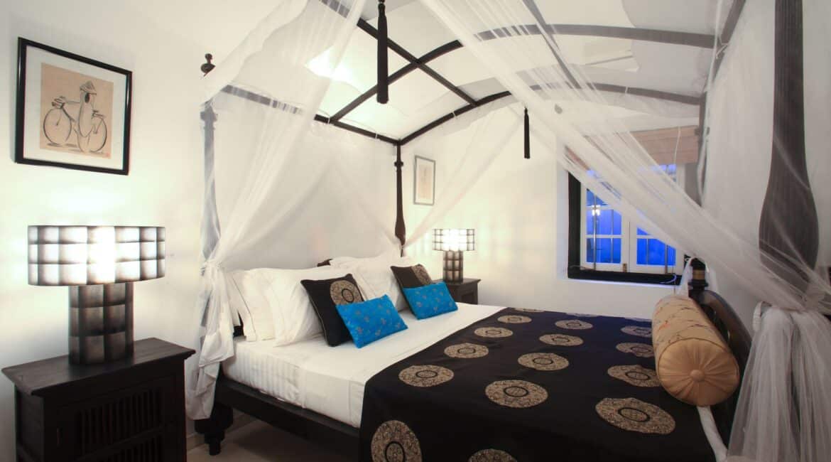 Kundhira Bedroom at Coco Tangalla near Tangalle, Sri Lanka – stylish black-and-white themed double room with four-poster queen bed