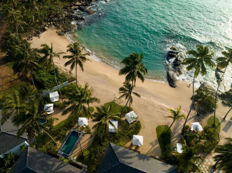 Aerial view of Ahu Bay Sri Lanka featuring the sandy beach, Indian Ocean, and pool rooms with private plunge pools overlooking the water.