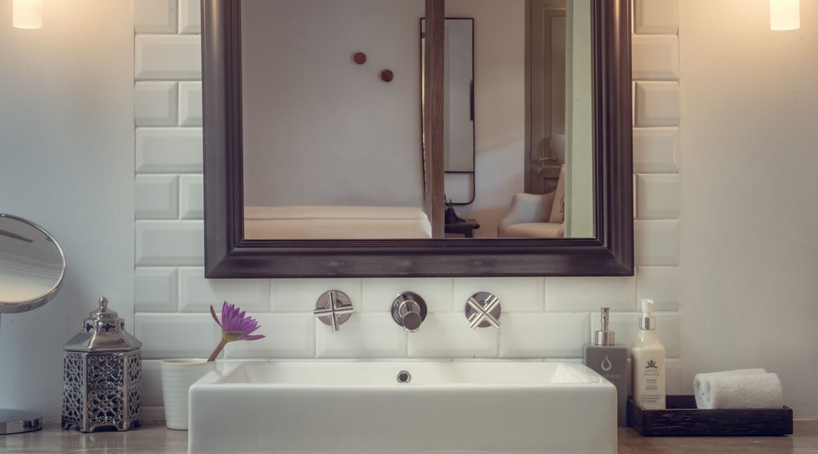 Modern bathroom in the Bazaar Bedroom at Fort Bazaar Hotel Sri Lanka, with a glass-enclosed shower, contemporary sink, and sleek fixtures.