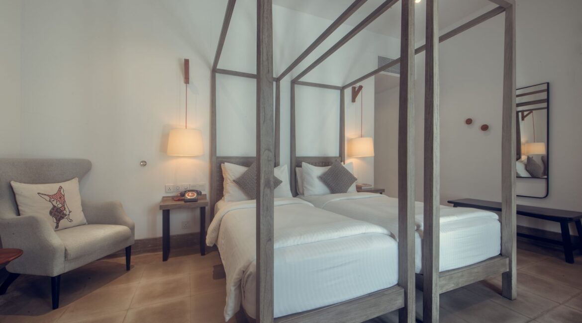 Banyan Bedroom Twin at Fort Bazaar Hotel Sri Lanka with bright, modern interiors, two single beds dressed in white linens, and minimalist furnishings.