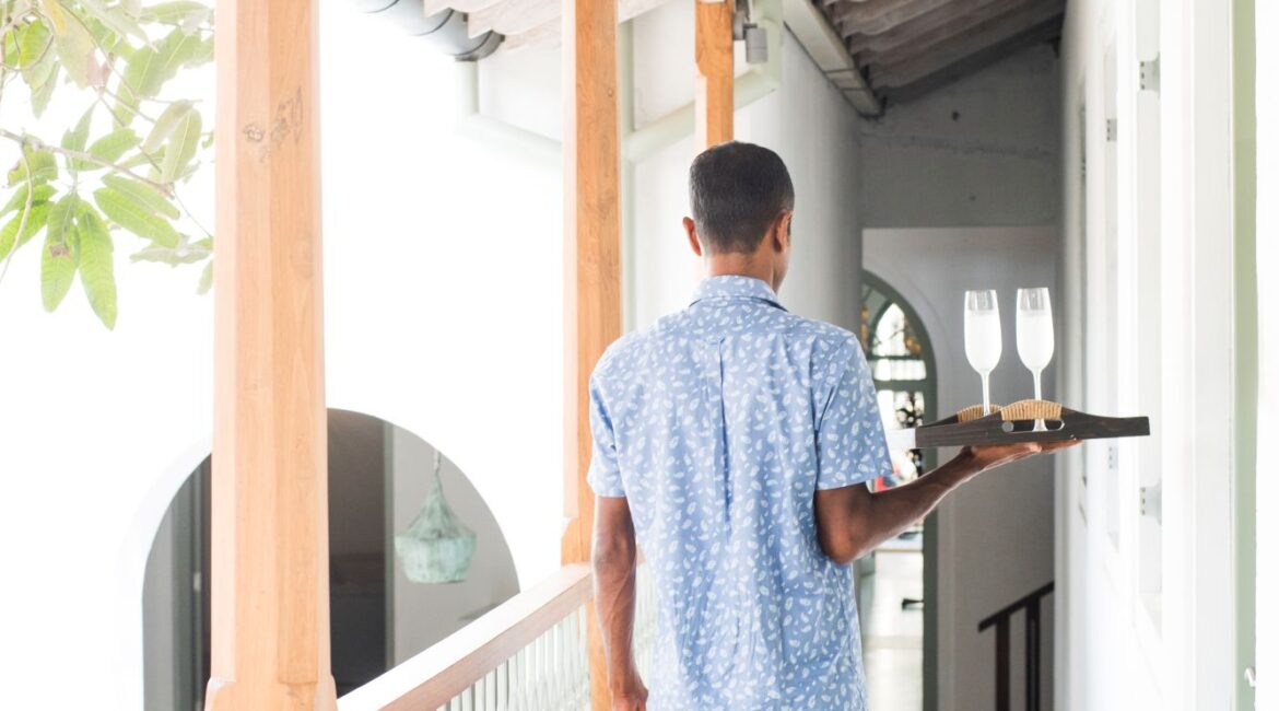Room service at Fort Bazaar Hotel Sri Lanka with a beautifully presented tray including fresh juice, tea, and breakfast dishes served in the guest room.