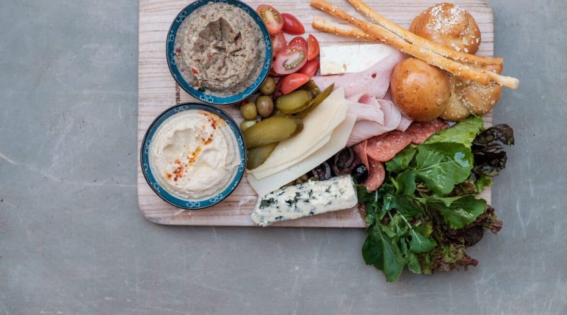 Grazing board at Fort Bazaar Hotel Sri Lanka with an assortment of cheeses, cured meats, fresh fruit, nuts, and crackers beautifully arranged on a wooden platter.