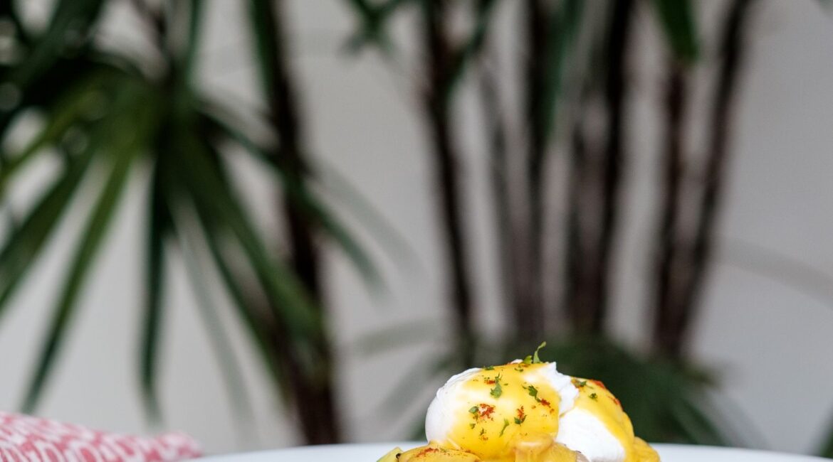 Delicious poached eggs served for breakfast at Fort Bazaar Hotel Sri Lanka, presented on toast with fresh greens and a side of grilled tomatoes.