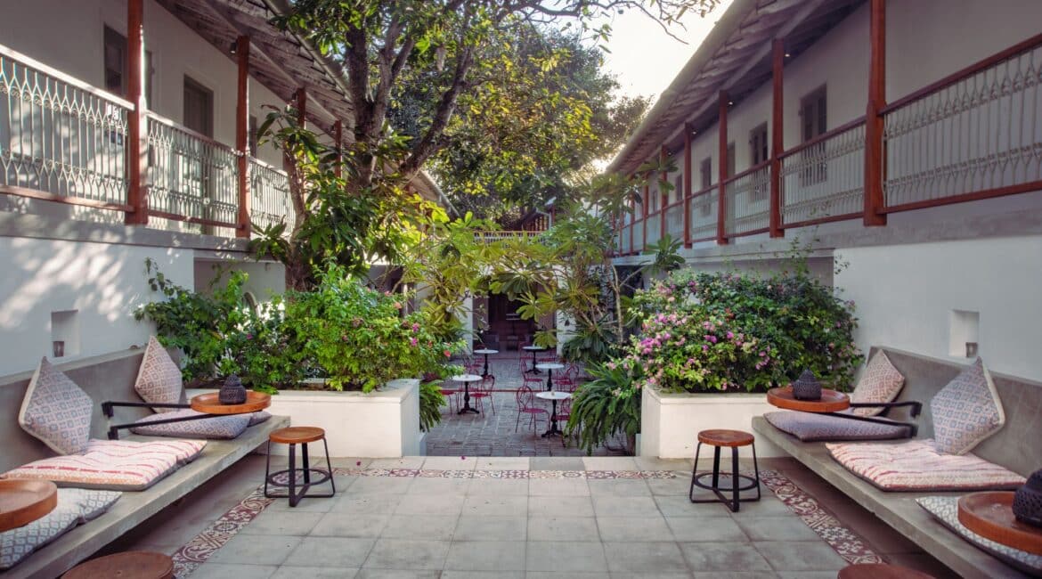 Comfy, modern furnished courtyard at Fort Bazaar Hotel Sri Lanka with cushioned seating, low tables, and lush plants creating a relaxed atmosphere