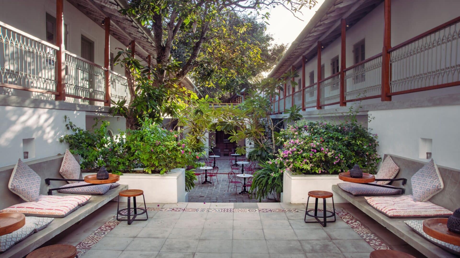 Comfy, modern furnished courtyard at Fort Bazaar Hotel Sri Lanka with cushioned seating, low tables, and lush plants creating a relaxed atmosphere