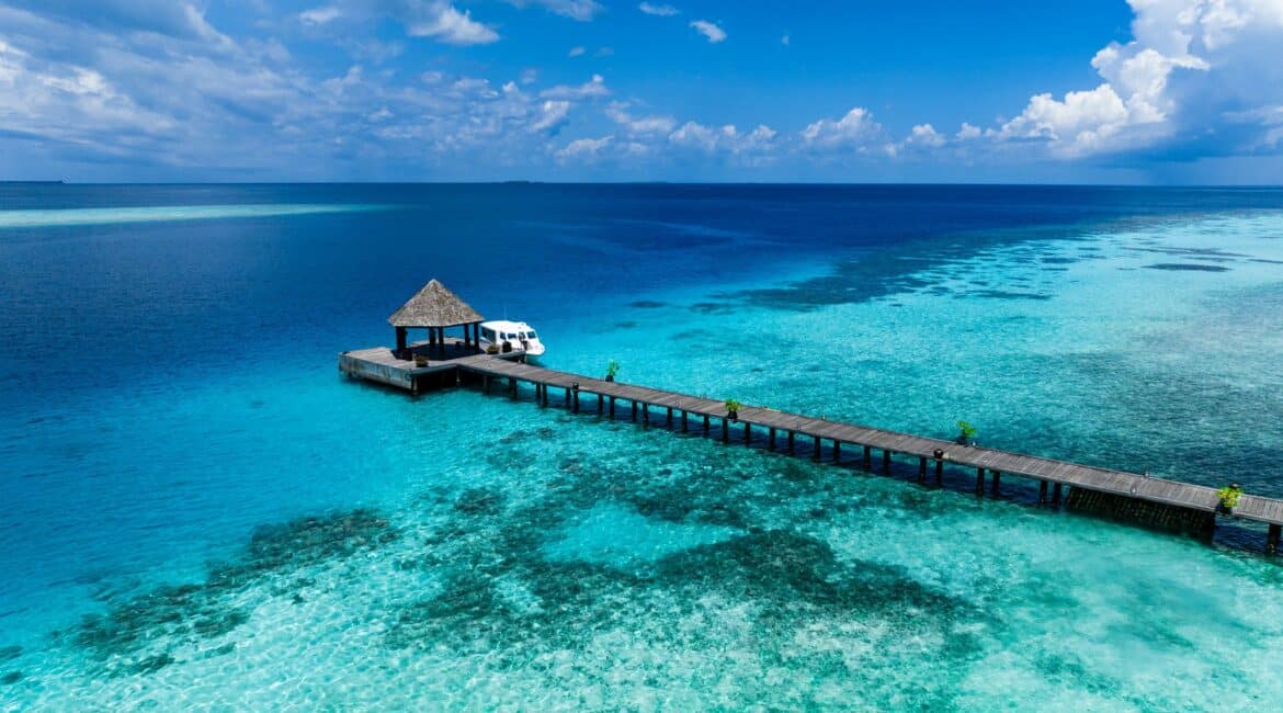 Komandoo Island Resort & Spa jetty surrounded by a thousand shades of blues