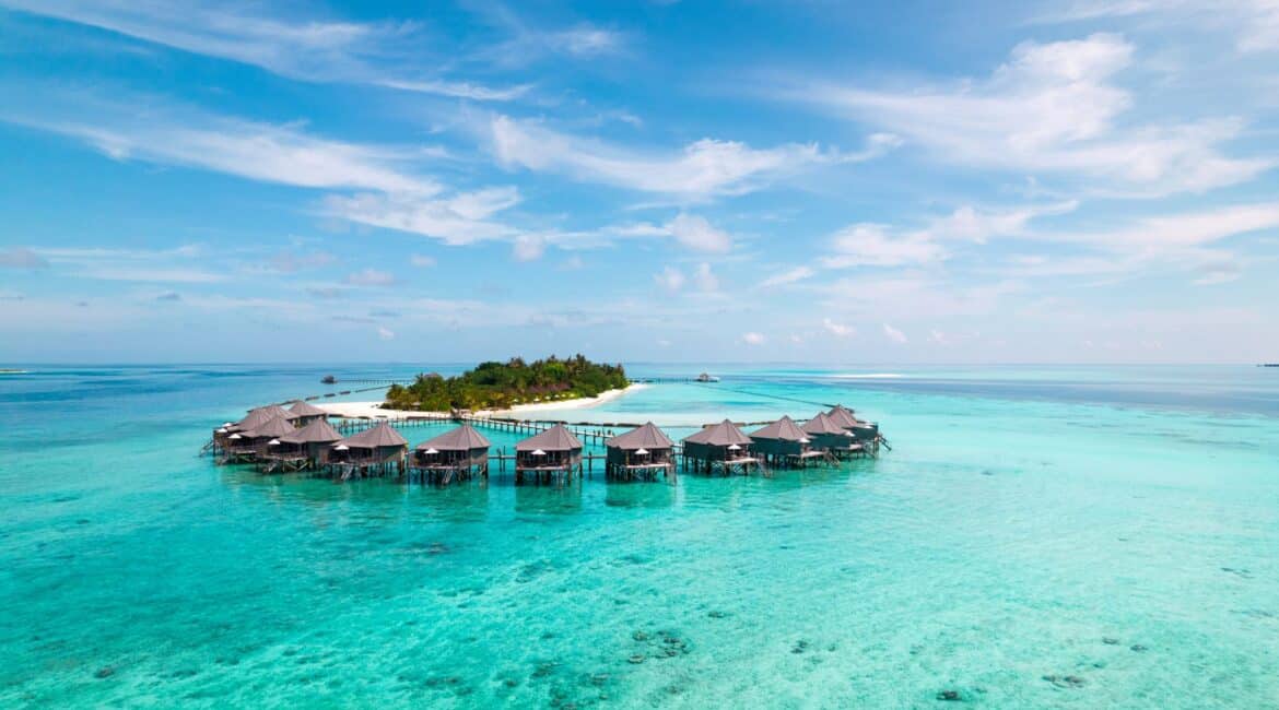 Komandoo Island Resort & Spa in the Maldives aerial footage of the bungalows over the sea