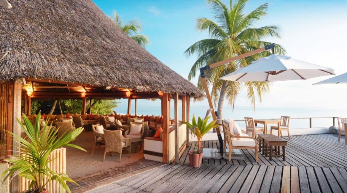 Makunudu Island Maldives stunning alfresco bar and dining area surrounded by palms and Indian Ocean Views