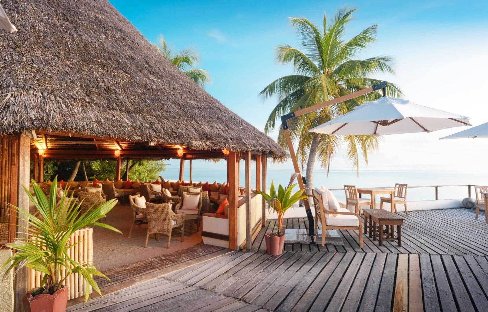 Makunudu Island Maldives stunning alfresco bar and dining area surrounded by palms and Indian Ocean Views