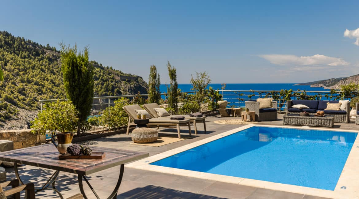 Villa Glaroni private pool overlooking the Ionian Sea surrounded by day beds Braunis Horio Kefalonia