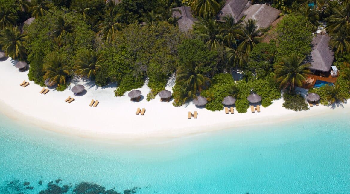 Baros Resort stunning white sand and crystal clear turquoise water palm fringe and soft white sand Maldives