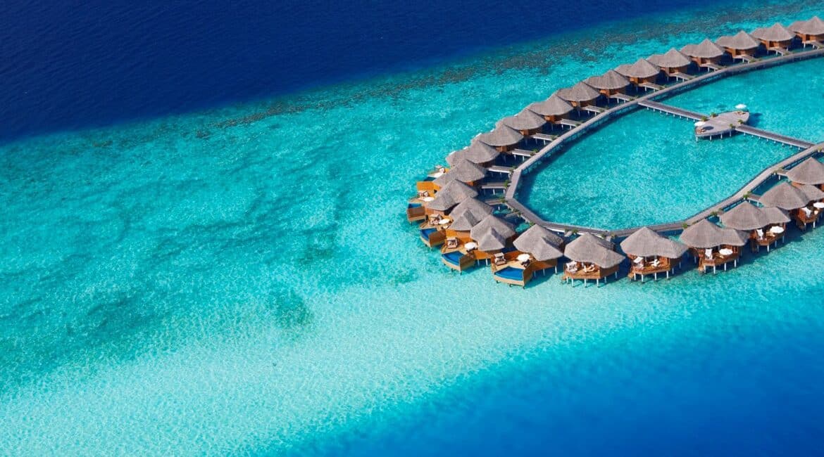 Baros Hotel bright blue sea and villas over the Indian Ocean crystal clear seas in the Maldives