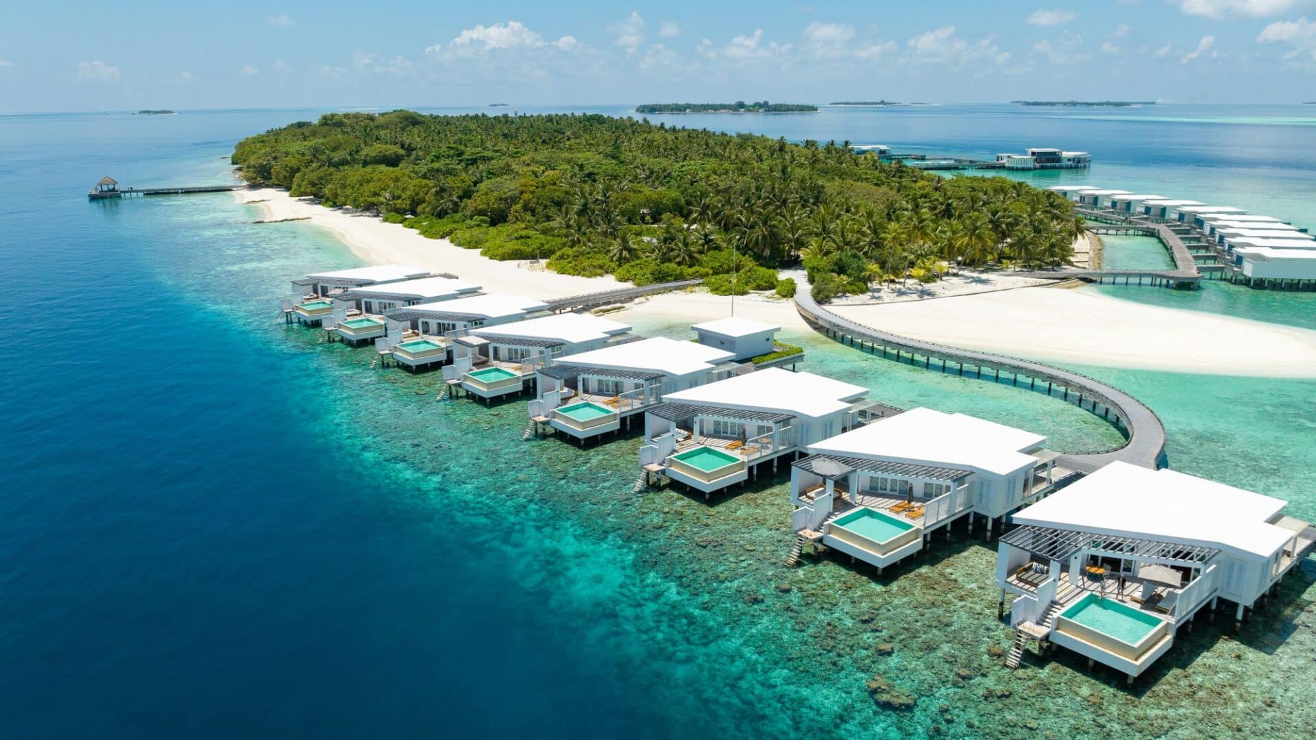Overwater villas and turquoise lagoon at Amilla Maldives