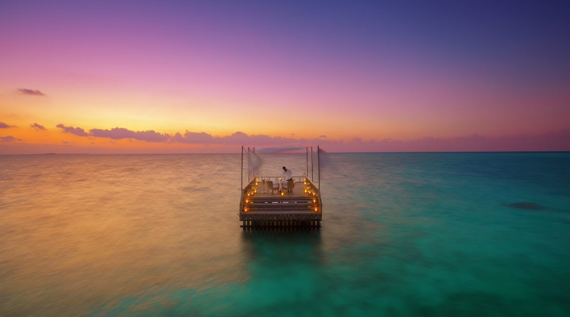 Baros Maldives Piano Deck Dinner against glorious pink skies