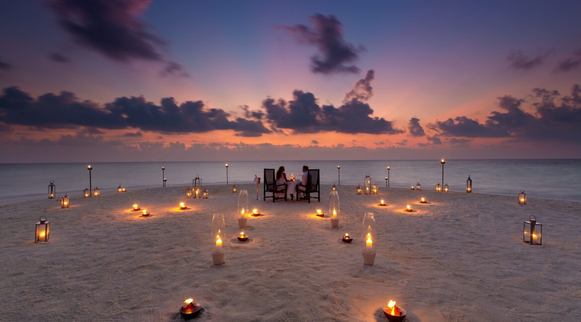 Baros Maldives Sandbank Dining and bright pink skies