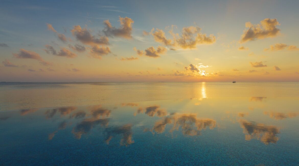 Baros Maldives swimming pool and gorgeous sunset skies