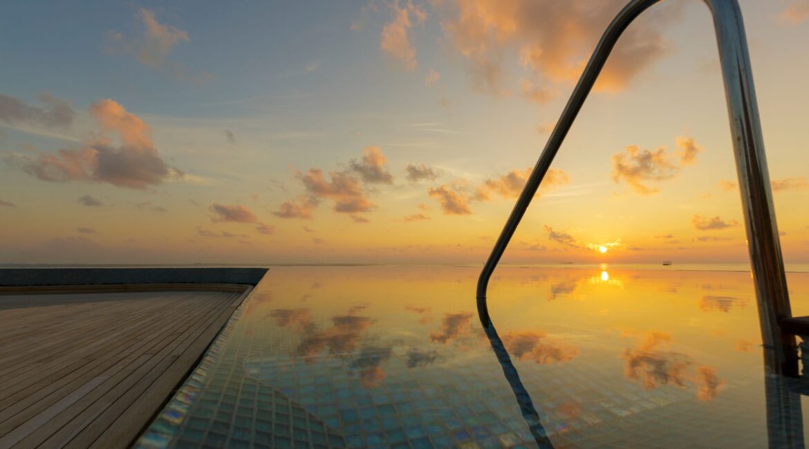 Baros Maldives swimming pool at sunset