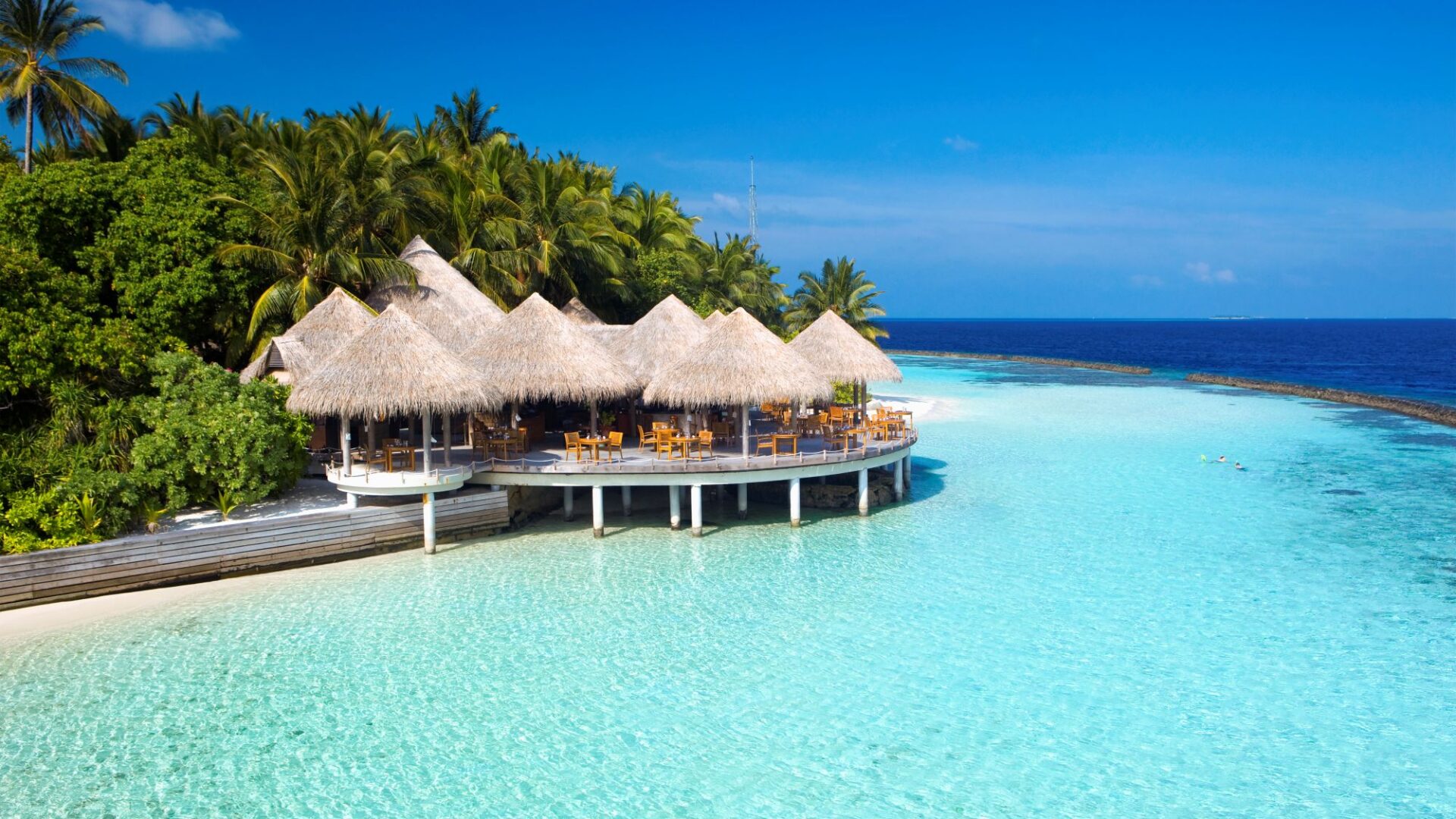 Island dining at Baros Maldives, set against turquoise seas at Cayenne