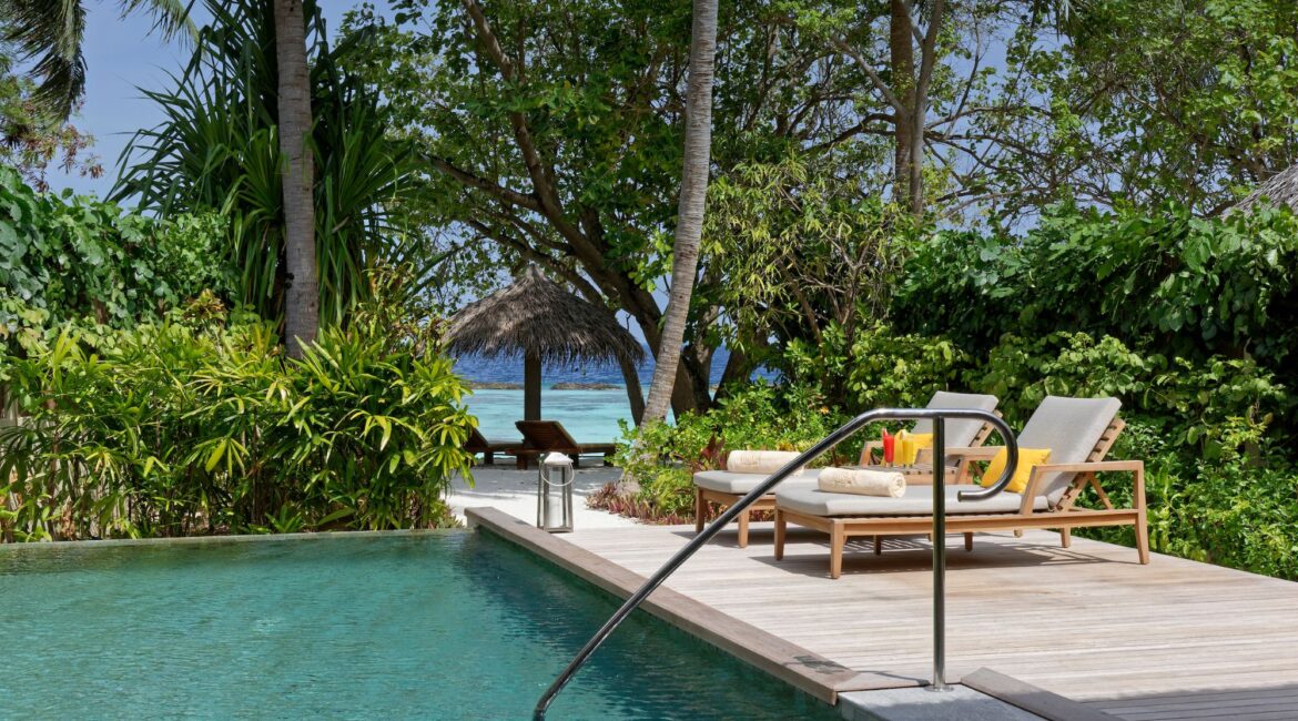 Baros Residence With Private Pool surrounded by jungle fringe day beds and decking Maldives