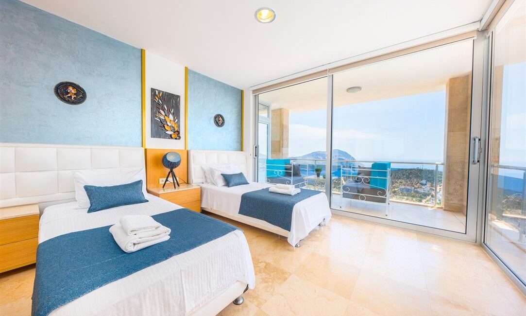 Villa Kayra in Kalkan modern twin bedroom with floor to ceiling glass windows framing the views