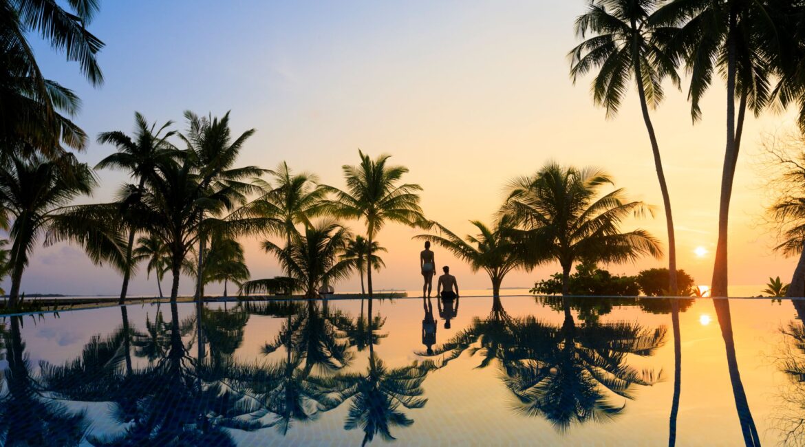 Dhigali Maldives hero sunset over the swimming pool and sea