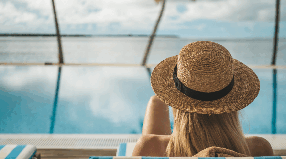 A lady relaxing poolside at Reethi Faru Resort in the Maldives