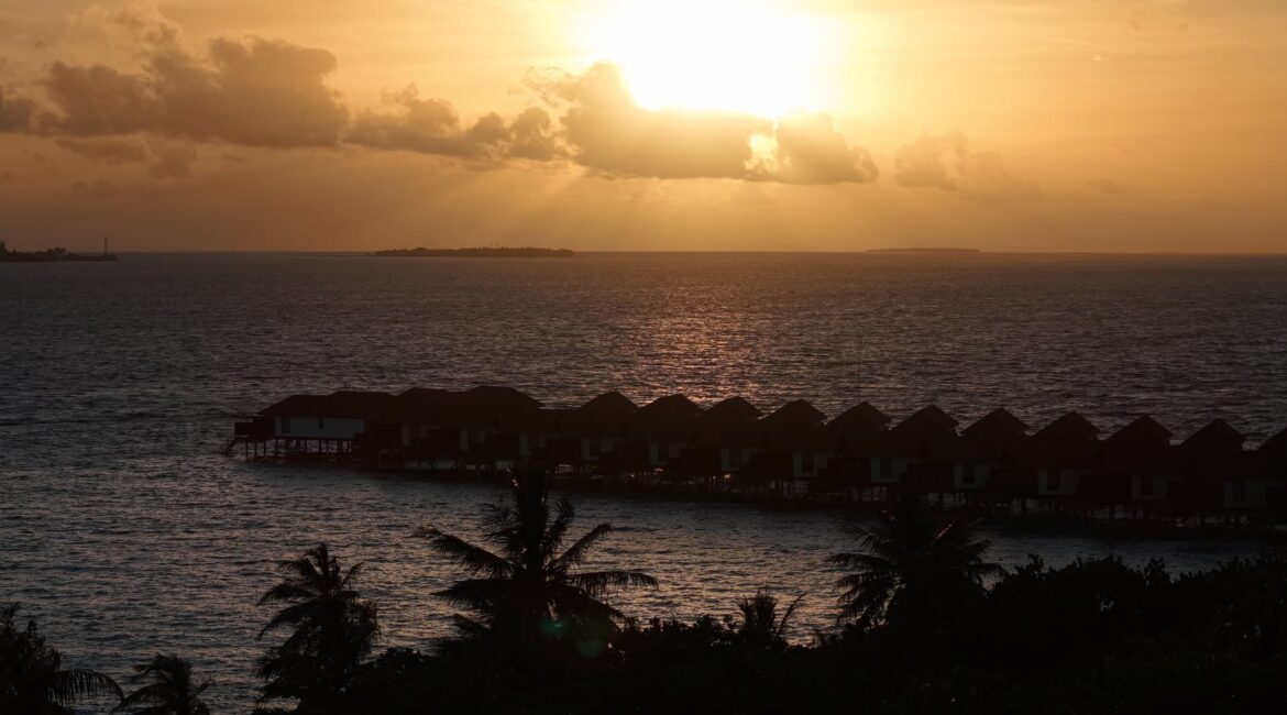 Water Villas at sunset Reethi Faru Maldives