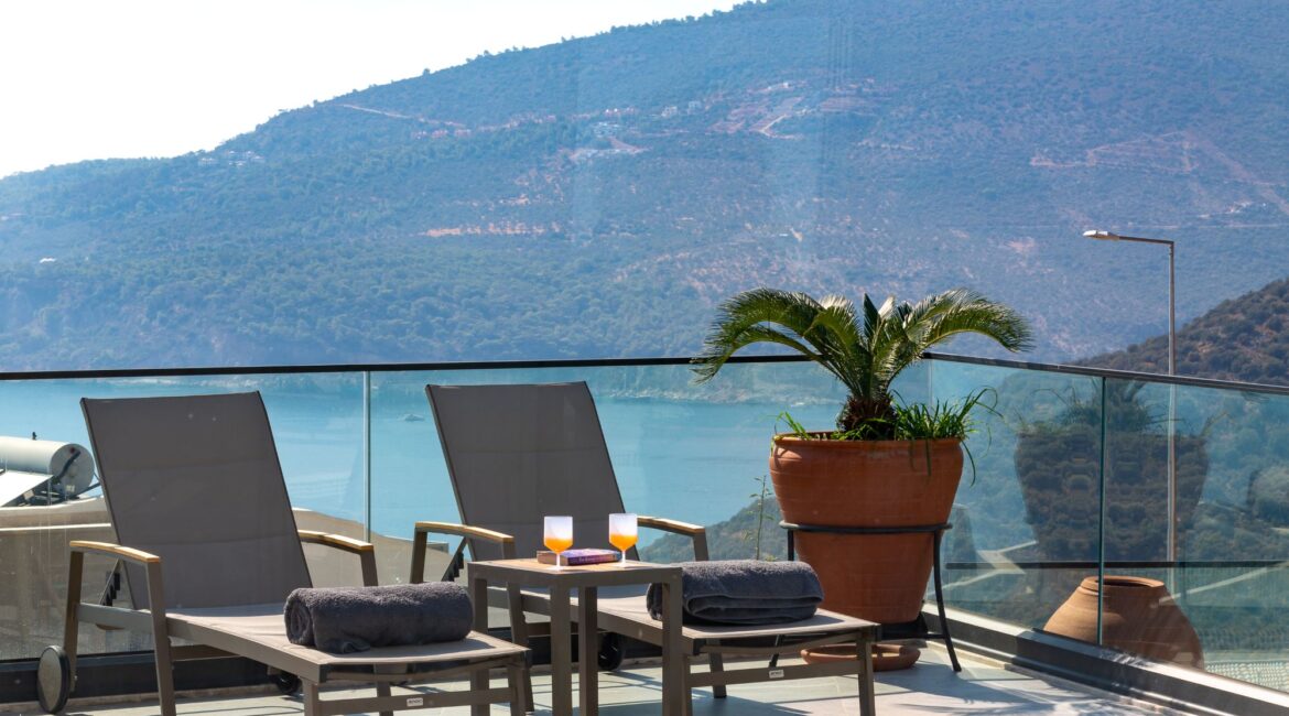 Olive House day beds against sea view backdrop in Kalamar Bay