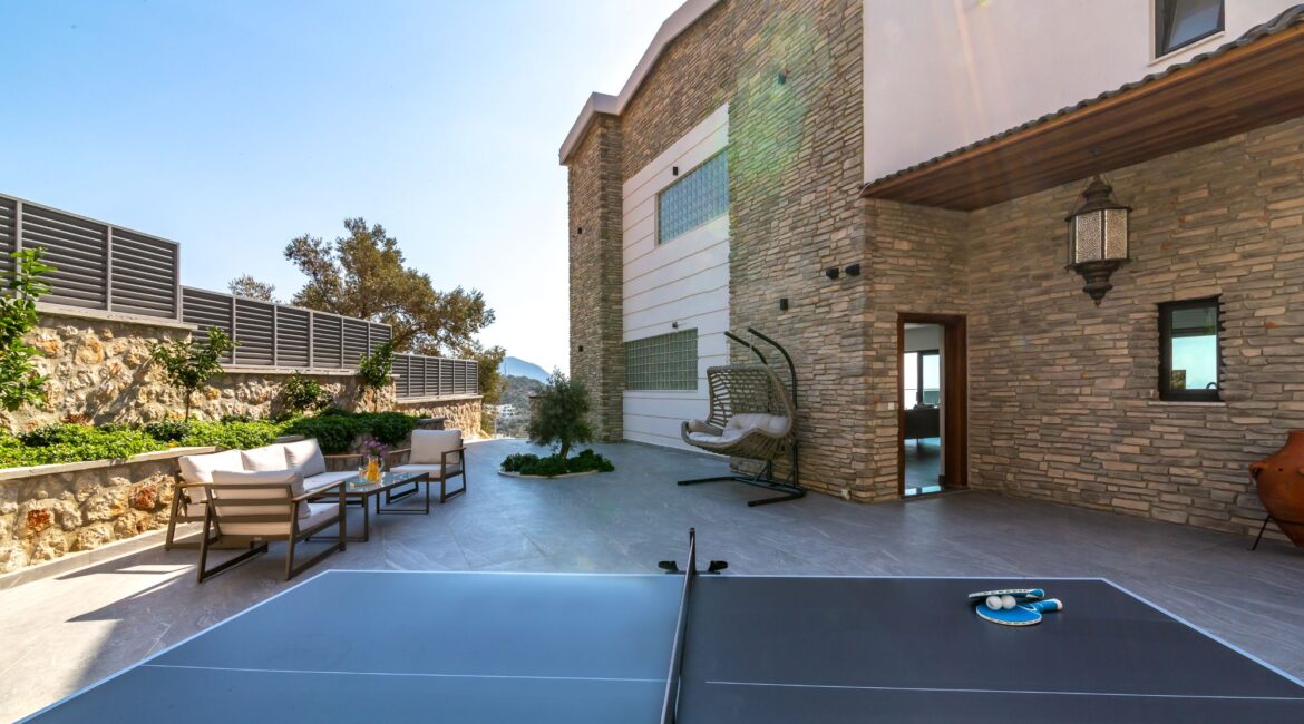 The Olive House rear of the villa alfresco seating area chair swing and table tennis Kalkan Turkey