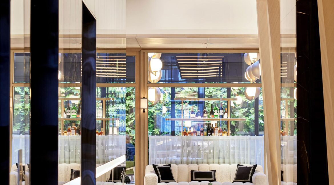 Entrance corridor at Vakko Hotel & Residence Nisantasi Istanbul with patterned marble floors and architectural wood panels.