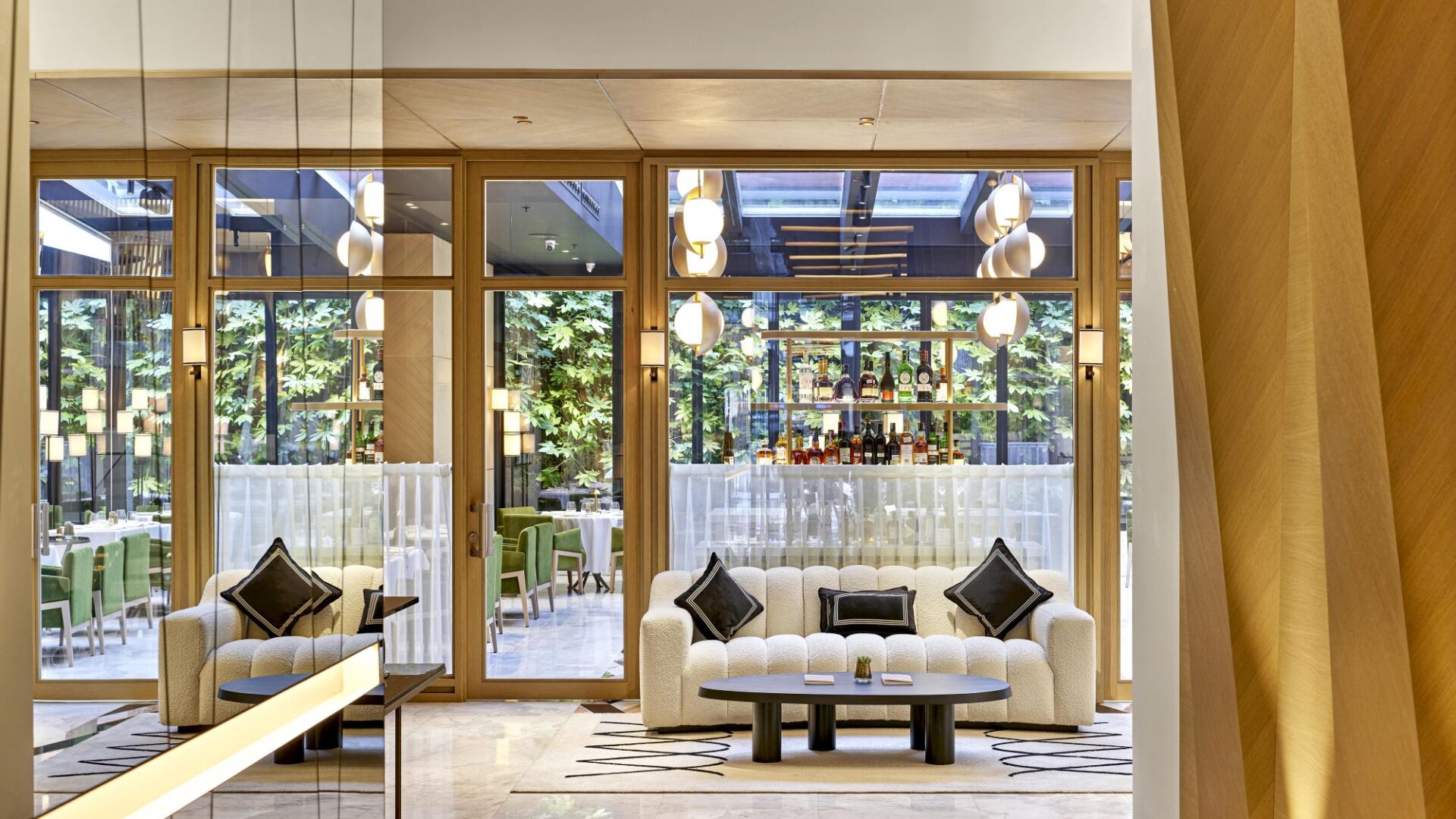 Glass-fronted lobby lounge at Vakko Hotel & Residence Nisantasi overlooking the elegant streets of Nisantasi.