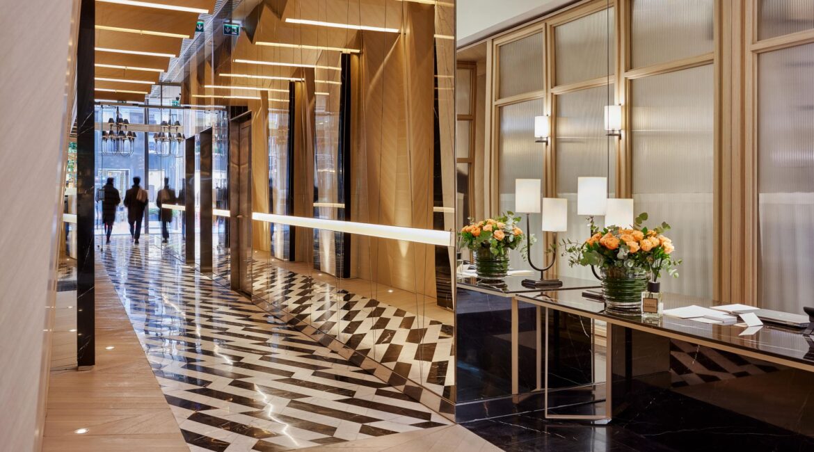 Lobby interior at Vakko Hotel & Residence Nisantasi Istanbul with marble flooring and warm wood detailing.