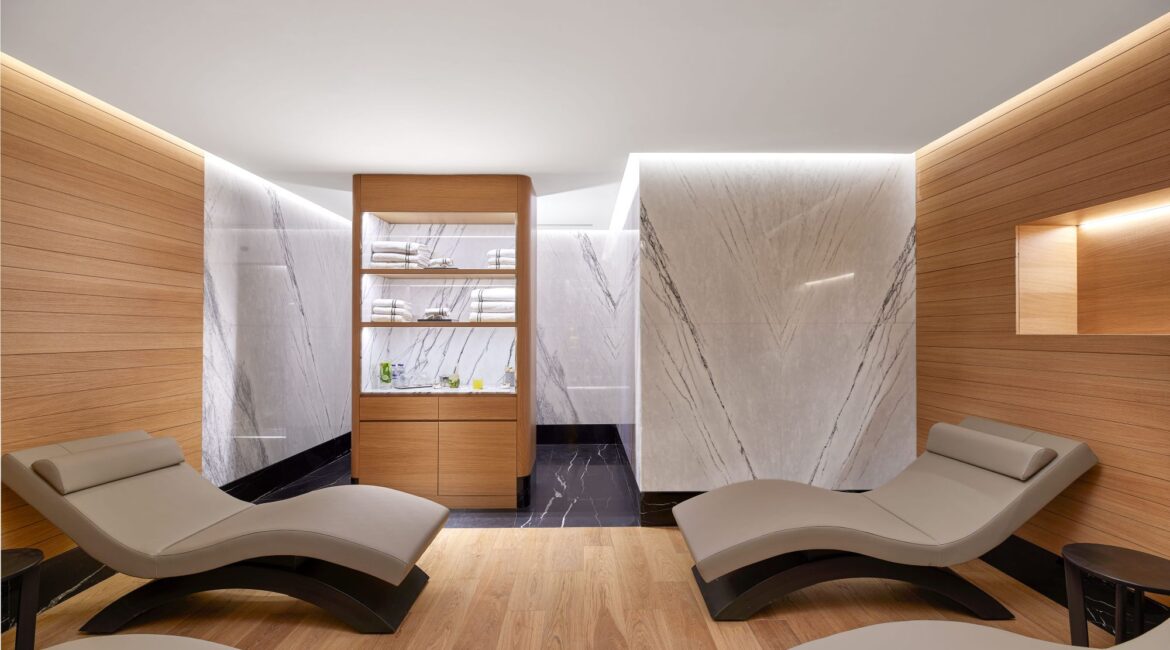 Relaxation lounge at Sanitas Spa in Vakko Hotel & Residence Nisantasi featuring heated loungers and marble walls.
