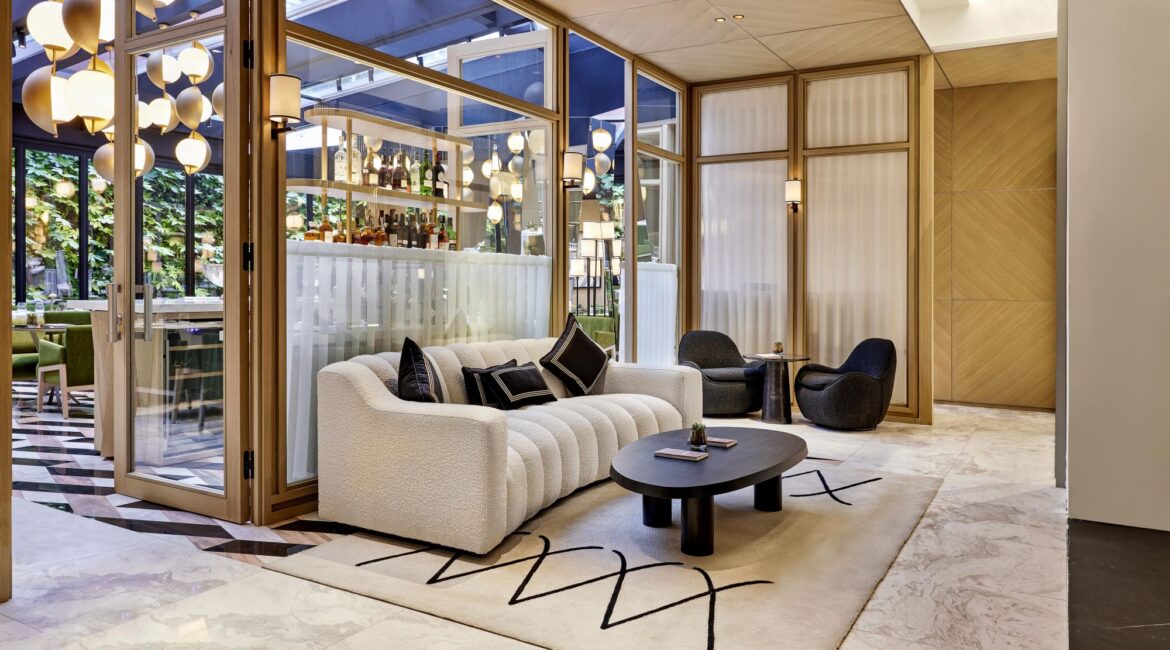 Seating area in the lobby of Vakko Hotel & Residence Nisantasi featuring contemporary design and floor-to-ceiling windows.