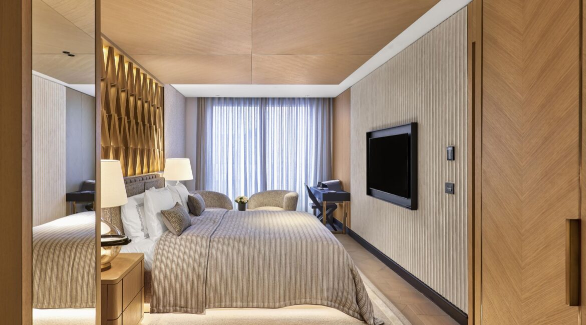 Premiere City Suite bedroom at Vakko Hotel & Residence Nisantasi Istanbul with king bed and wood-panel detailing.