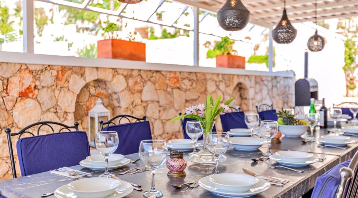 Covered alfresco dining terrace at Villa Bahce Kalkan beside the pool.