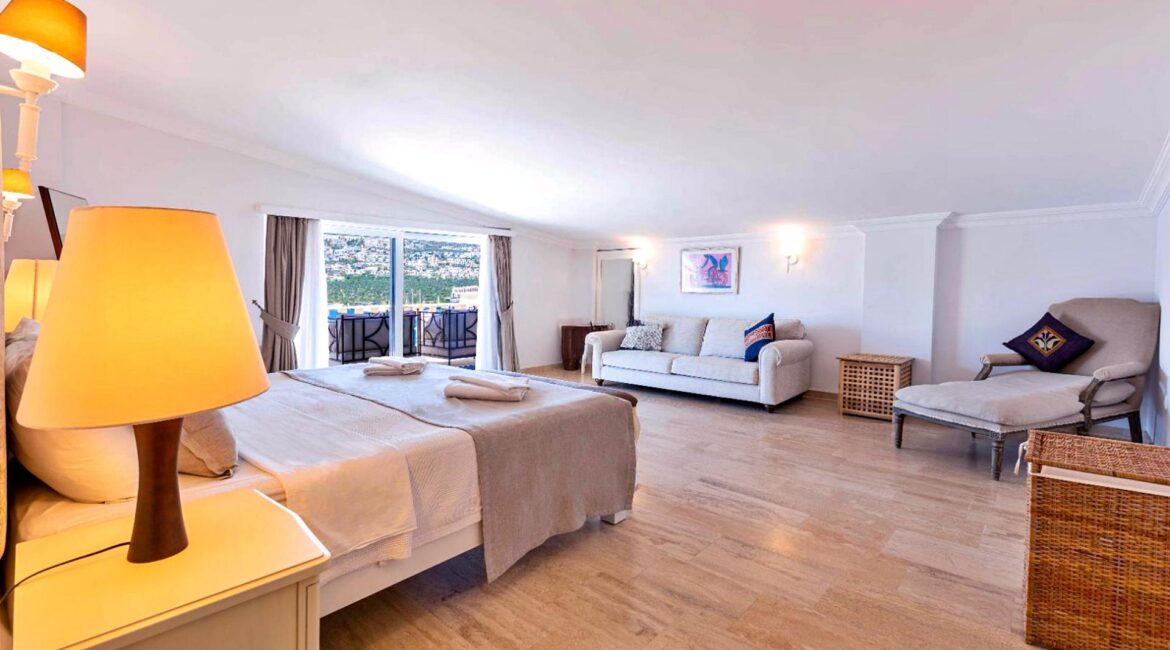 First-floor double bedroom at Villa Bahce Kalkan with sea-view balcony and spacious seating area