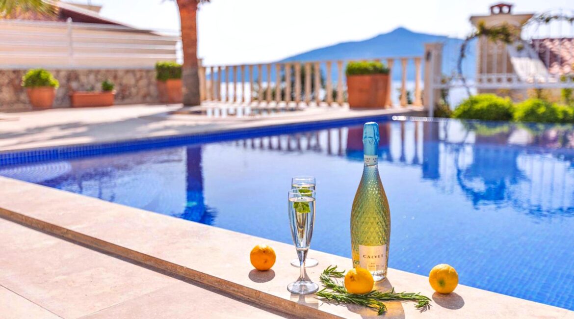 Private swimming pool terrace at Villa Bahce Kalkan with drinks beside the pool and sea views.