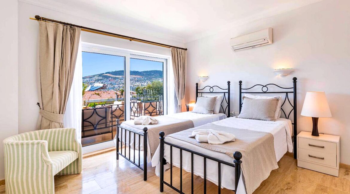 Twin bedroom at Villa Bahce Kalkan with large window and sea views